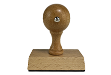 Wooden stamp with a round head on a white background